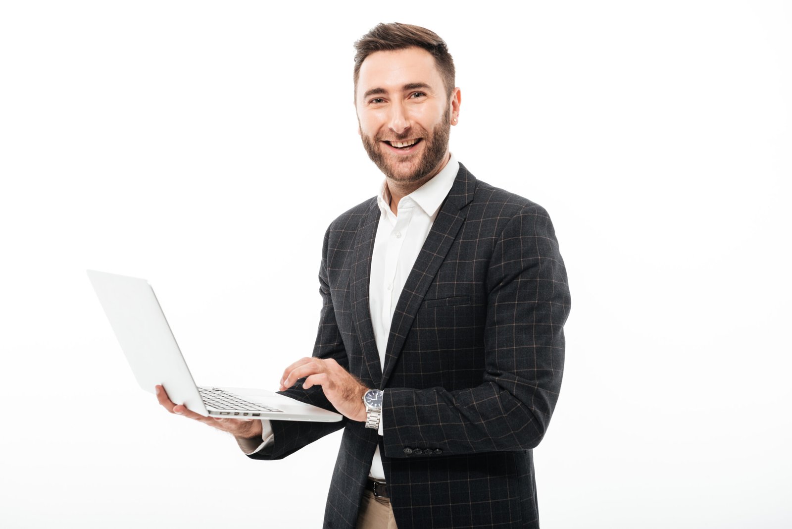 Portrait of a smiling bearded man holding laptop computer and looking at camera isolated over white background